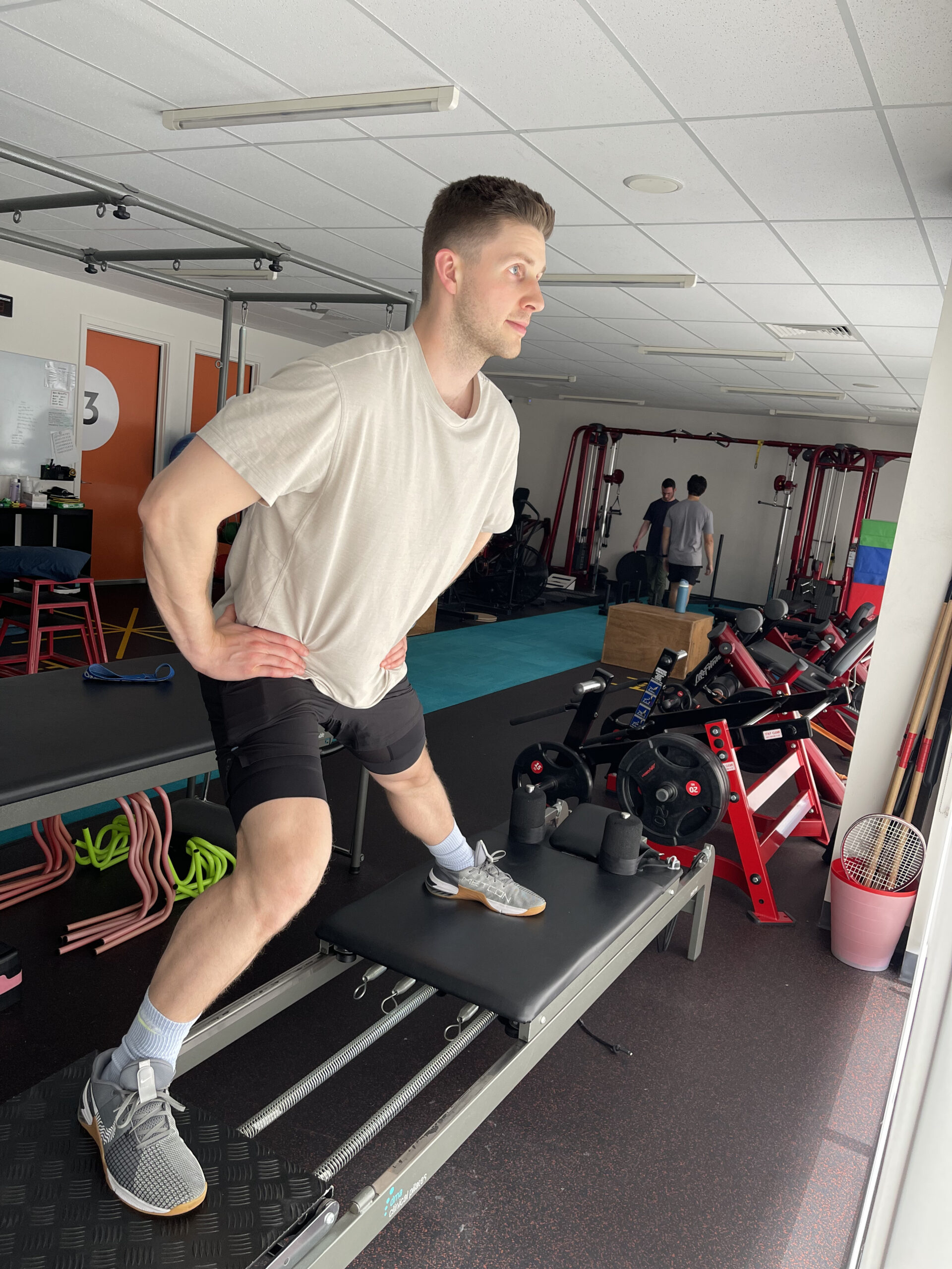 A patient performing leg exercises during a clinical pilates session