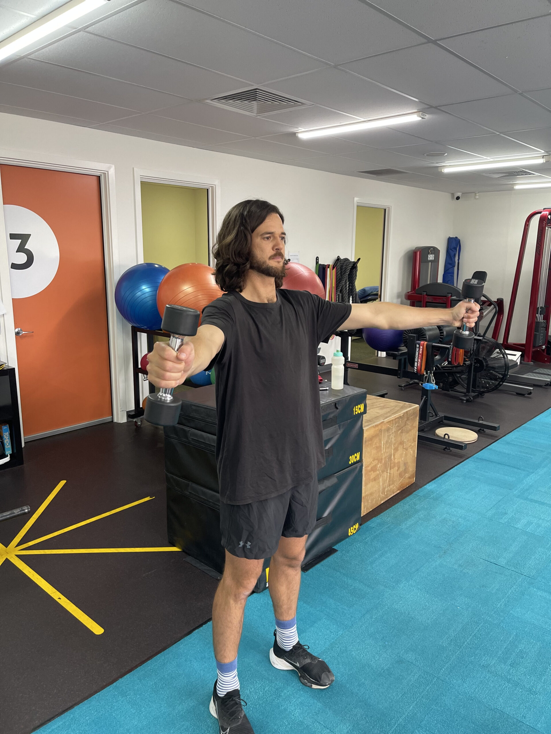 A patient exercising under the guidance of a sports physio in Adelaide