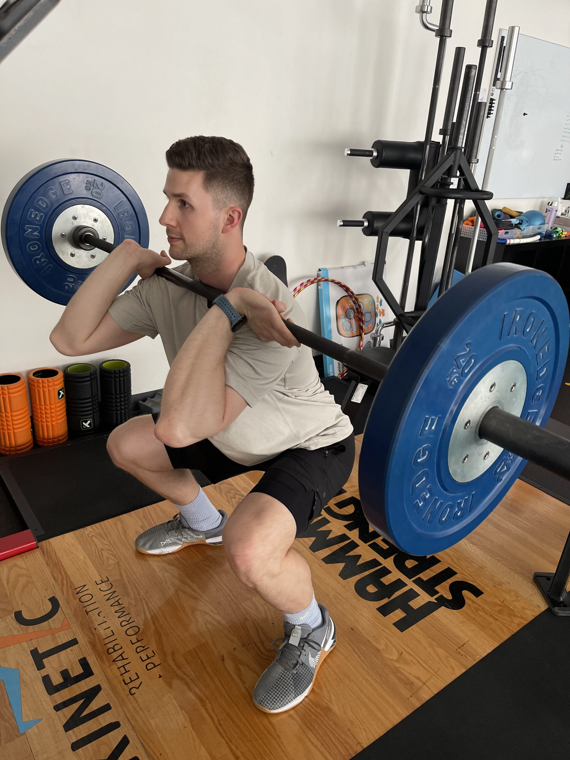 A patient undergoing rehabilitation on gym equipment guided by a sports physio in Adelaide