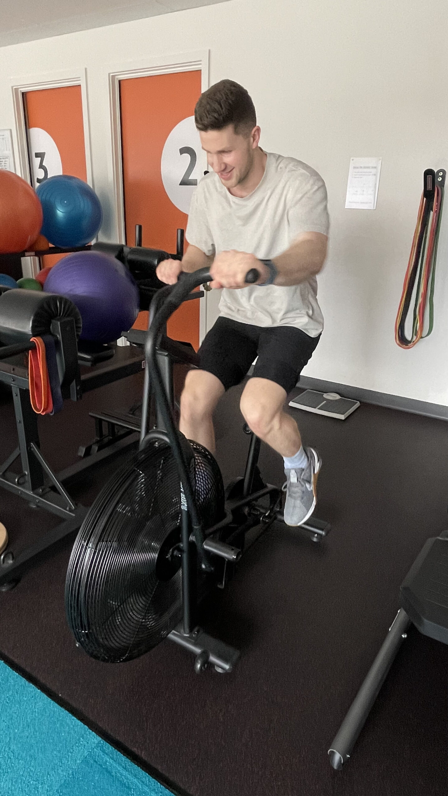 A man using gym equipment during a sports physio session in Adelaide